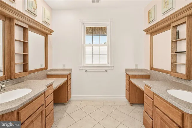 front view of a brick house with a yard and table and chairs