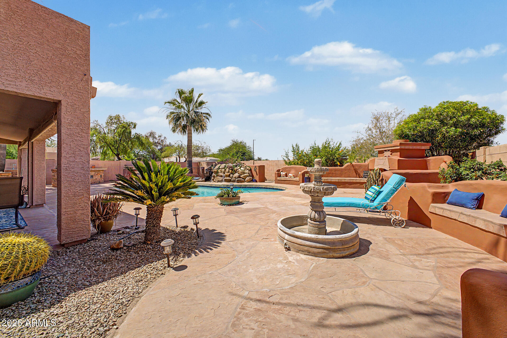 3948 North Ranier Mesa, AZ 85215 - Photo 43 of 69 a view of a backyard with table and chairs potted plants and palm tree