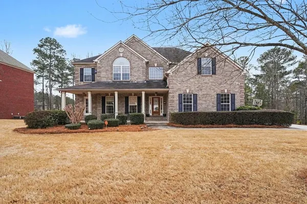 a front view of a house with yard and porch