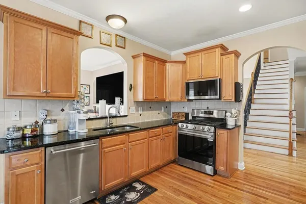 a kitchen with a sink stove and microwave
