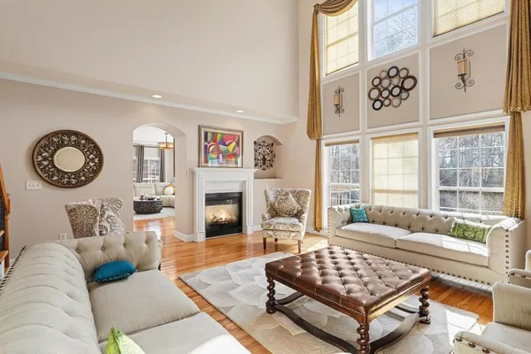 a living room with furniture a table and a large window