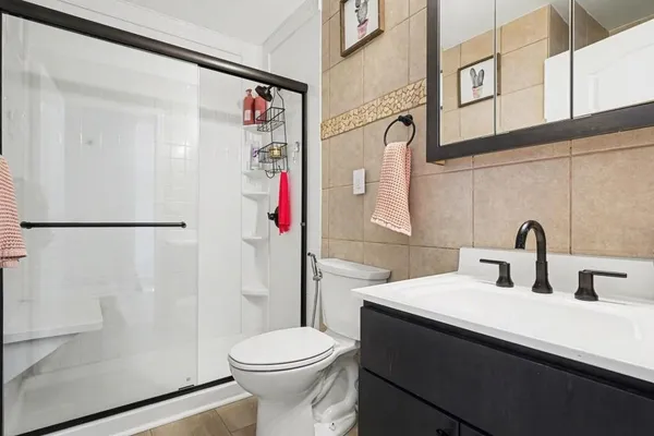 a bathroom with a sink toilet and shower