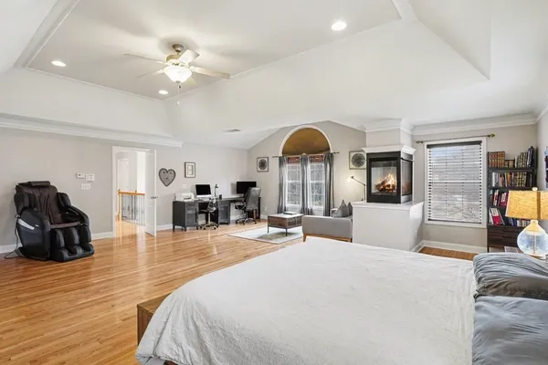 a bedroom with furniture and a large mirror
