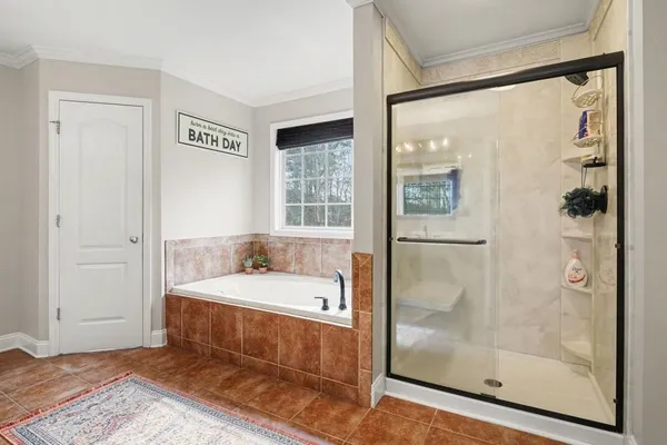 a bathroom with a tub and a shower
