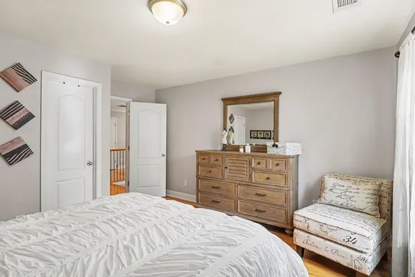 a bedroom with a bed and a dresser