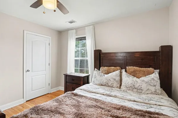 a bedroom with a bed and a window