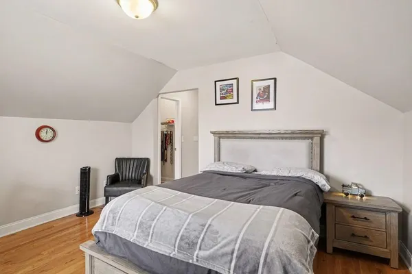 a bedroom with a bed and a tv on table