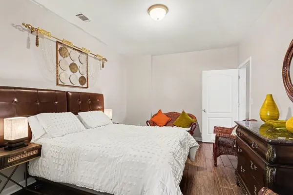a bedroom with a bed and wooden floor