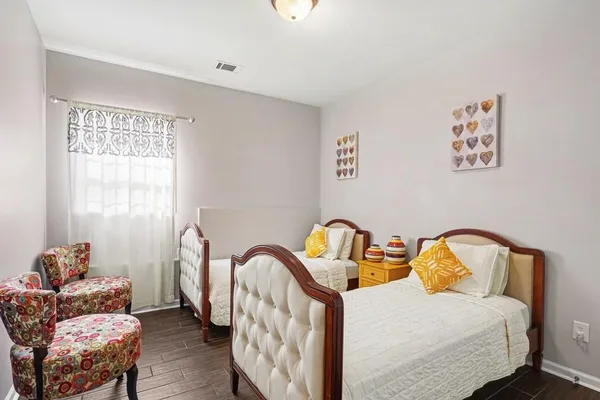 a bedroom with a bed a couch and dresser