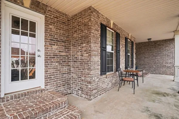 a balcony with a bench and a window