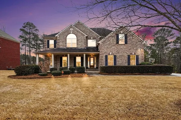 a front view of a house with yard and outdoor seating