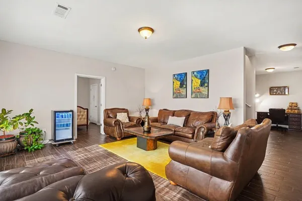 a living room with furniture chess board and a potted plant
