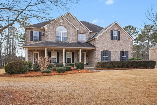 a front view of a house with a yard