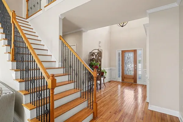 a view of entryway and hall with wooden floor
