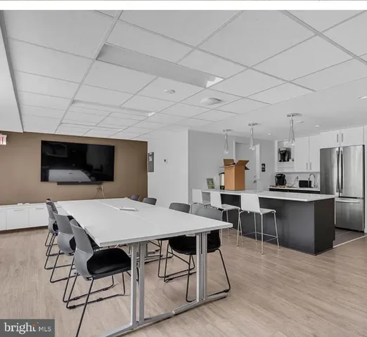 a view of kitchen with kitchen island and stainless steel appliances
