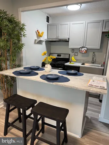 a kitchen with a table chairs stove and cabinets