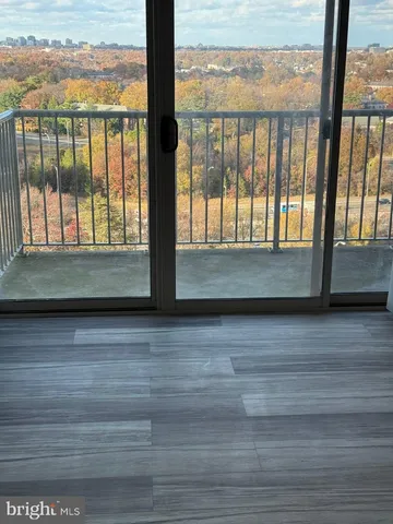 a view of a balcony with a floor to ceiling window next to a yard