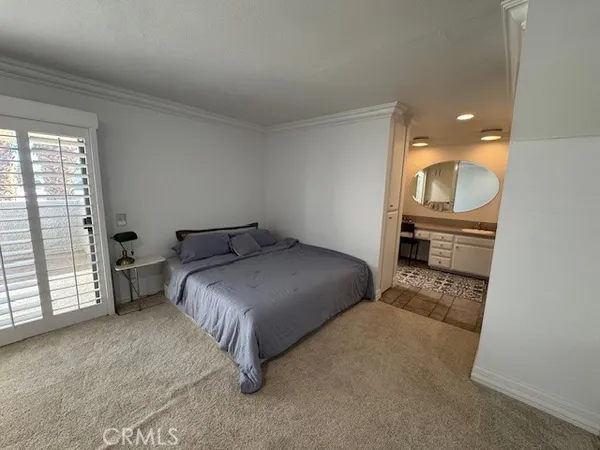 a bedroom with a bed and a mirror