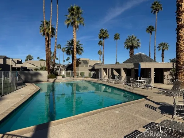 swimming pool view with a garden space