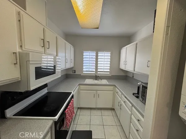 a kitchen with a sink a stove and cabinets