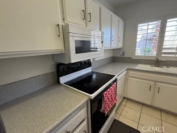 a kitchen with stainless steel appliances a stove microwave and cabinets
