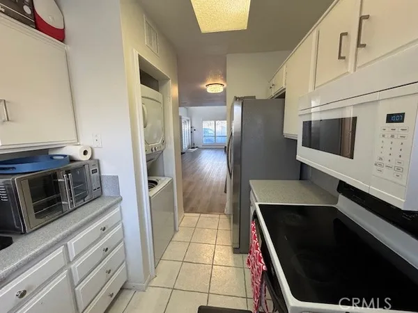 a kitchen with stainless steel appliances a refrigerator a stove a microwave and cabinets