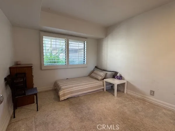 a bedroom with a bed and a chair