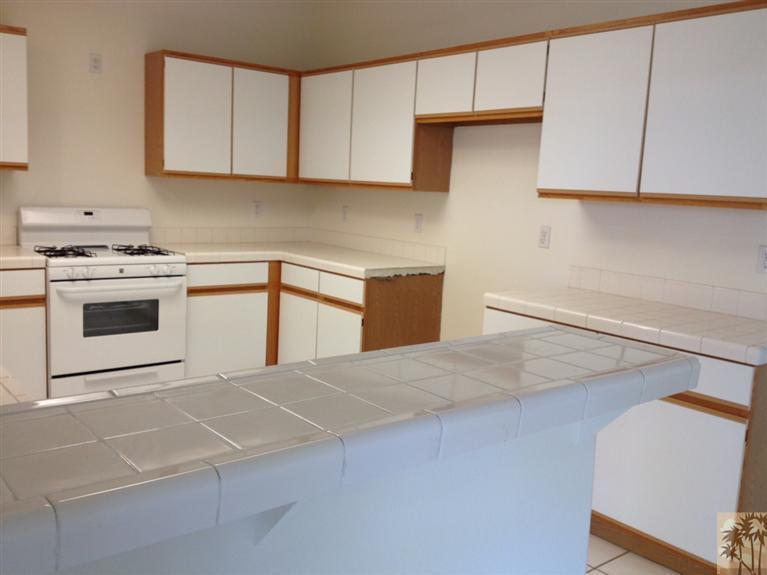 68260 Risueno Road Cathedral City, CA 92234 - Photo 13 of 25 a kitchen with cabinets and appliances