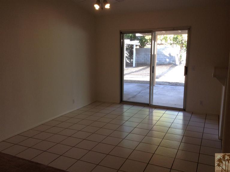 68260 Risueno Road Cathedral City, CA 92234 - Photo 15 of 25 an empty room with wooden floor and windows