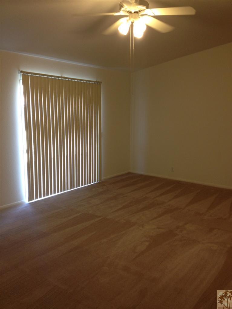 68260 Risueno Road Cathedral City, CA 92234 - Photo 17 of 25 a view of an empty room with a chandelier fan