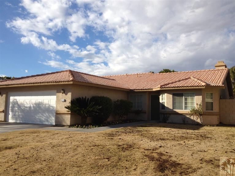 68260 Risueno Road Cathedral City, CA 92234 - Photo 3 of 25 a front view of a house with a yard and garage