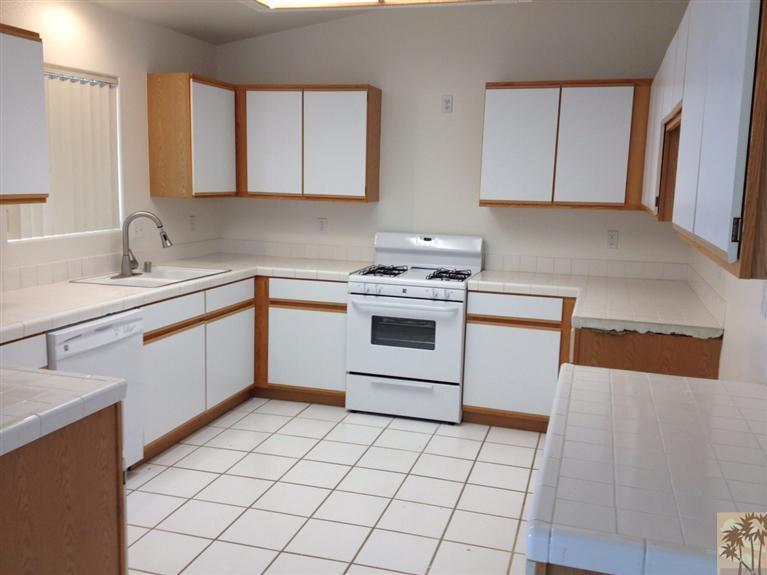 68260 Risueno Road Cathedral City, CA 92234 - Photo 10 of 25 a kitchen with a stove sink and cabinets