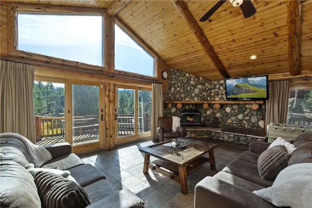 a living room with furniture and a floor to ceiling window