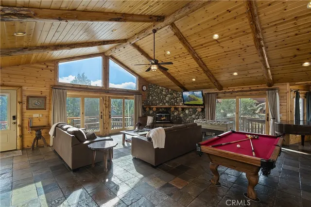 a living room with furniture a table and large windows