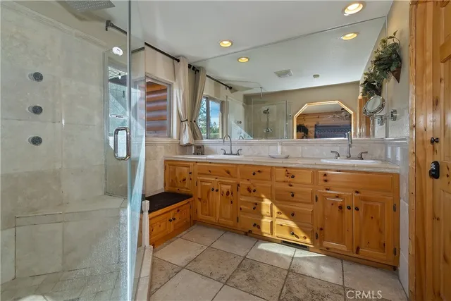 a bathroom with a granite countertop sink mirror and shower