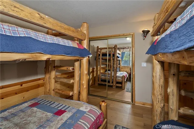 a bedroom with a bed and a mirror