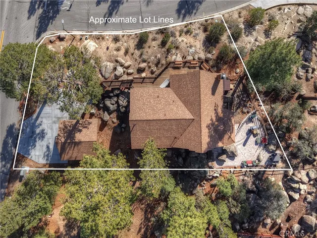 an aerial view of a house with a mountain in the background