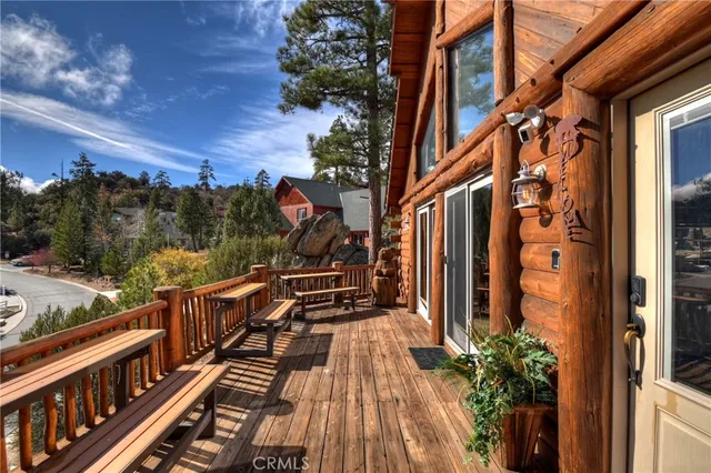 a view of balcony with wooden floor and fence