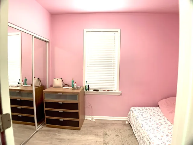 a bedroom with furniture and a window