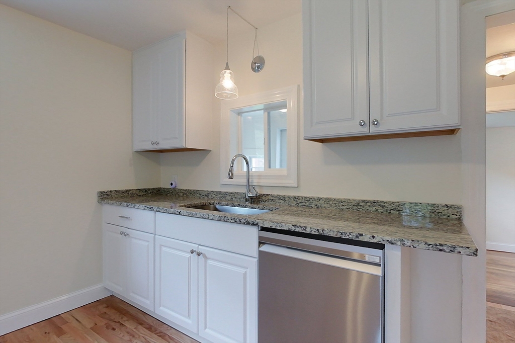 92 Squannacook Road Shirley, MA 01464 - Photo 3 of 38 a kitchen with granite countertop white cabinets and a sink