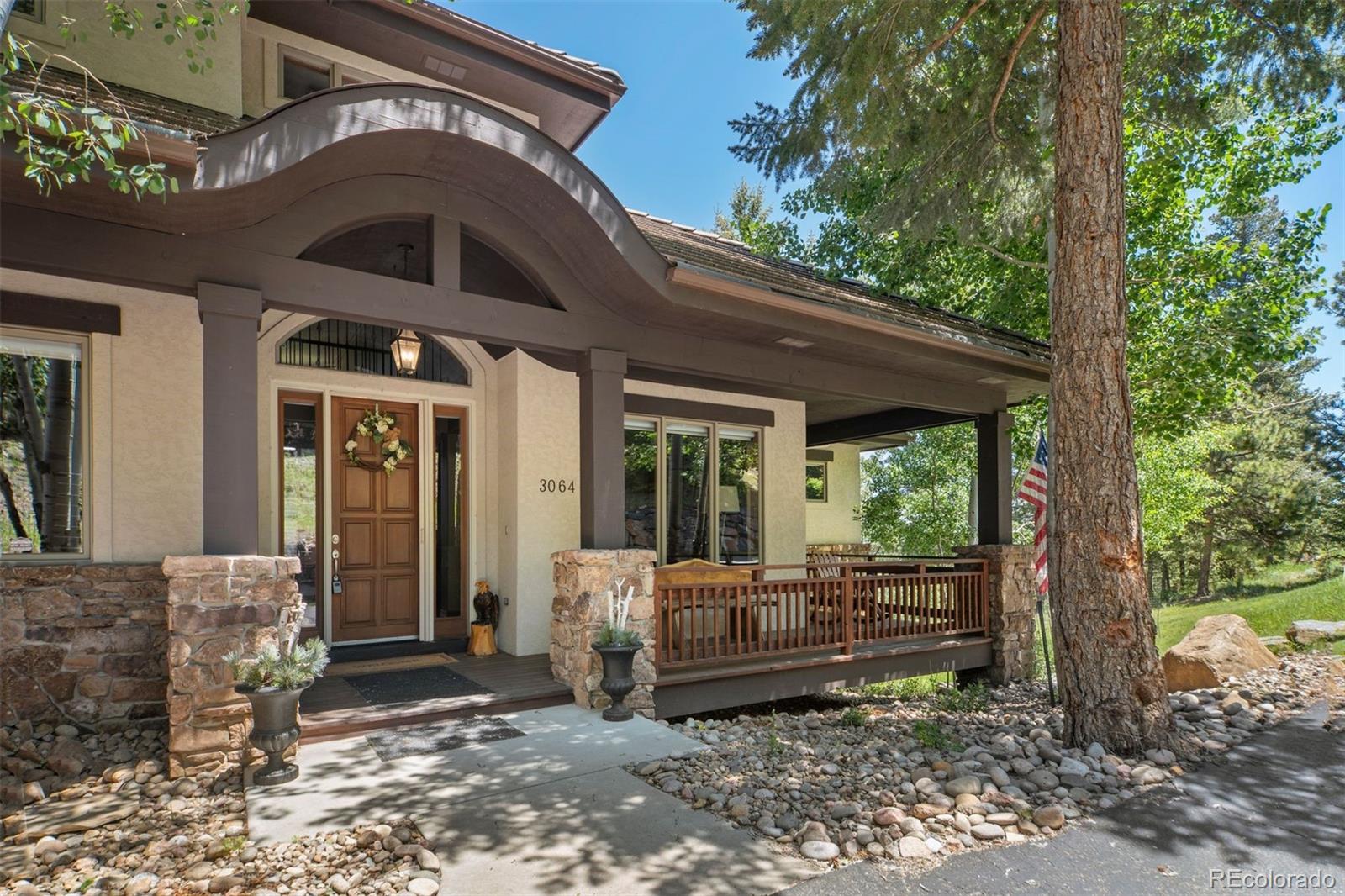 a view of a porch with furniture and floor to ceiling window