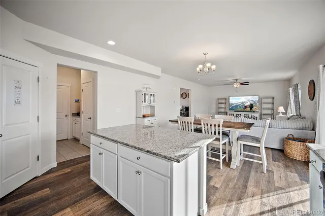 a living room with furniture a flat screen tv and a window