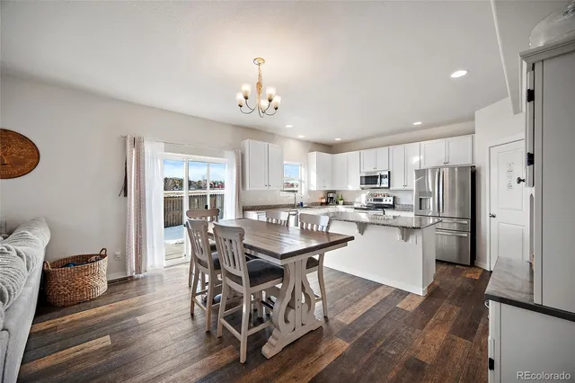 a kitchen with a refrigerator a sink and cabinets