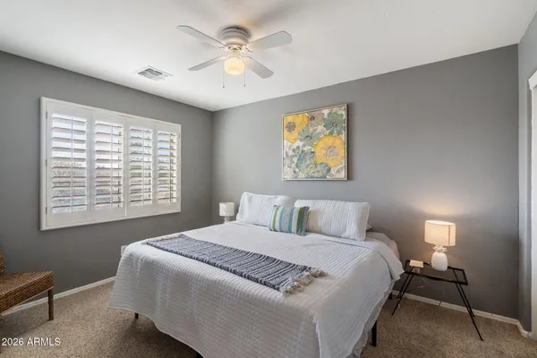 a bedroom with a large bed and a window