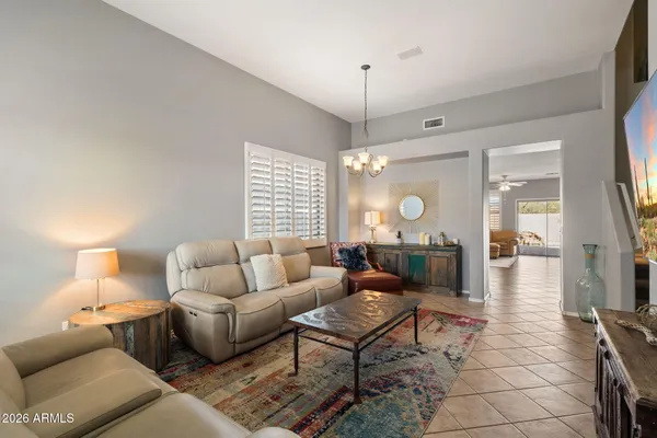 a living room with furniture a lamp and a chandelier
