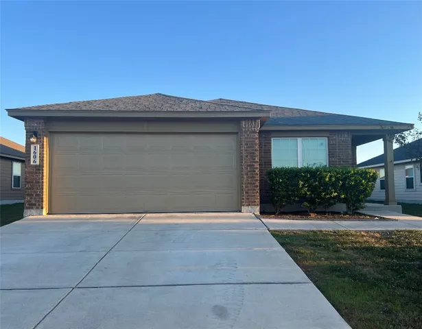 a front view of a house with yard