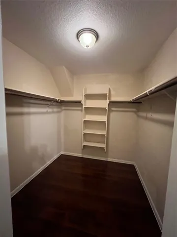 a view of a room with an empty space and wooden floor