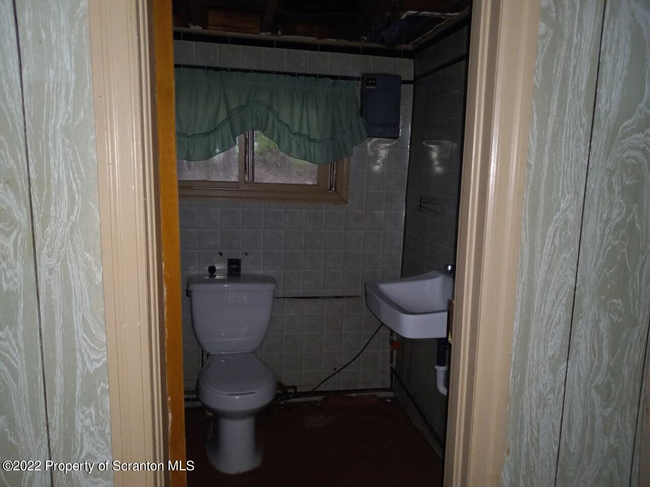 48 1/2 Indian Spring Road Tunkhannock, PA 18657 - Photo 11 of 15 a bathroom with a toilet and a sink