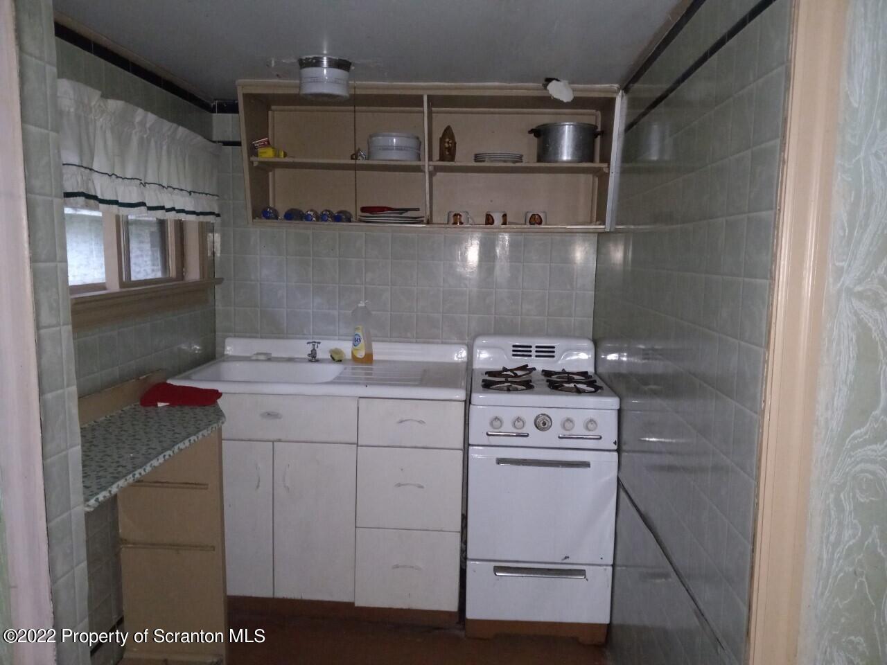 48 1/2 Indian Spring Road Tunkhannock, PA 18657 - Photo 8 of 15 a utility room with cabinets washer and dryer