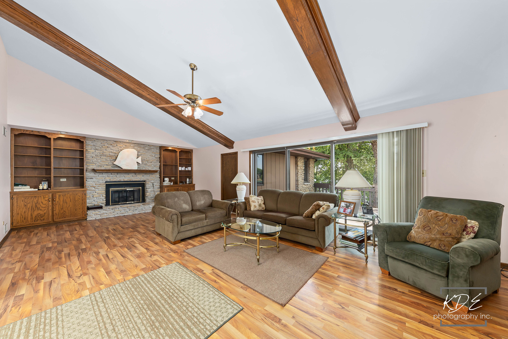 23211 Pilcher Road Plainfield, IL 60544 - Photo 12 of 58 a living room with furniture a fireplace and a flat screen tv